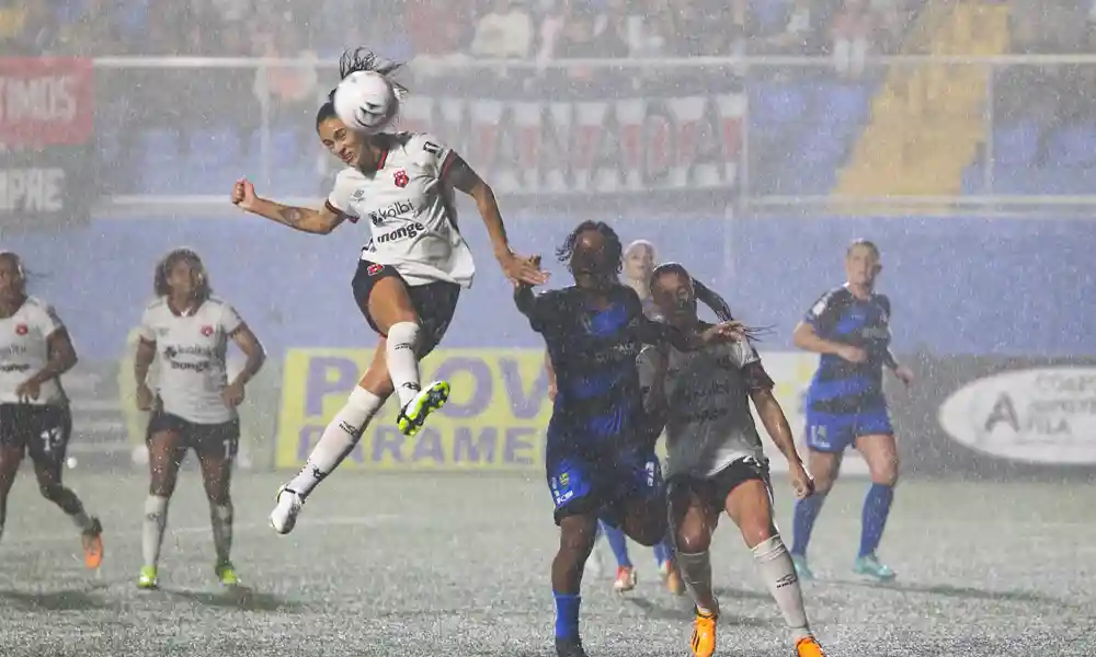 La lluvia acompañó a Sporting y Alajuelense en todo el partido. Aquí, Fabiola Villalobos no logra que se remate vaya al arco. Foto: LDA.